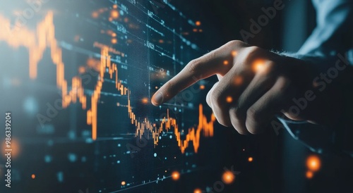 Analyzing stock market trends with a hand pointing at financial data on scree...