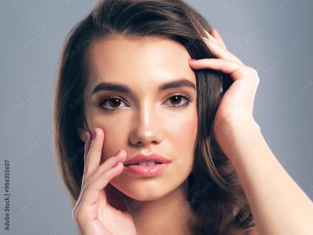 Makeup, hairstyle and portrait of woman in studio for glow, beauty and hair gloss treatment. Scalp health, salon and growth with person on gray background for haircare cosmetics, volume and keratin Makeup, hairstyle and portrait of woman in studio for glow, beauty and hair gloss treatment. Scalp health, salon and growth with person on gray background for haircare cosmetics, volume and keratin