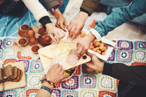 Food, picnic and snack table with people hands and fruit with bread and lunch for party and social event in park. Cheese board, sunshine and meal with meat, muffins and salami spread in summer