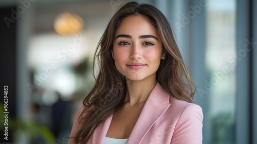 business woman in a pink blazer with a sleek office background, representing female empowerment and success in the corporate world