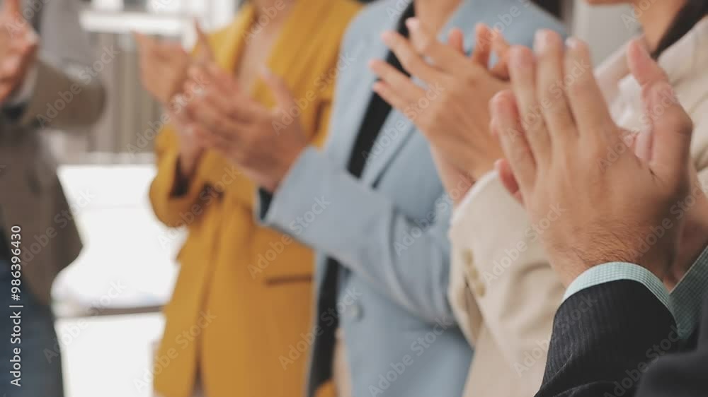 Group of young and senior businesspeople applauding during a speech or a ceremony Group of young and senior businesspeople applauding during a speech or a ceremony