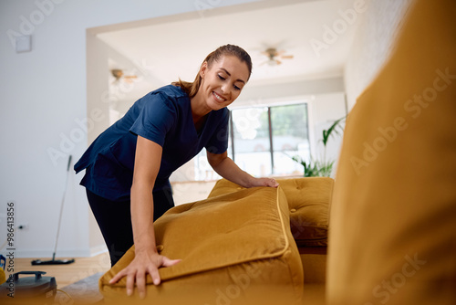 Young happy housekeeper at work.