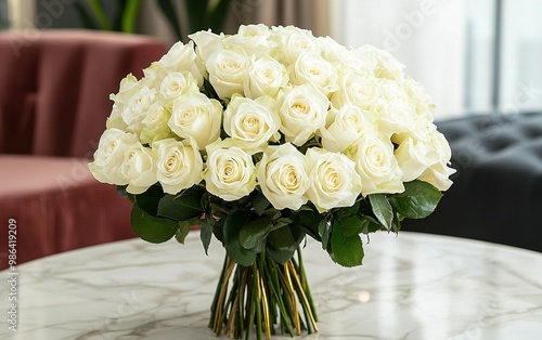 Elegant white roses in a glass vase on a luxurious table with decorative accessories, creating a serene atmosphere in a bright room