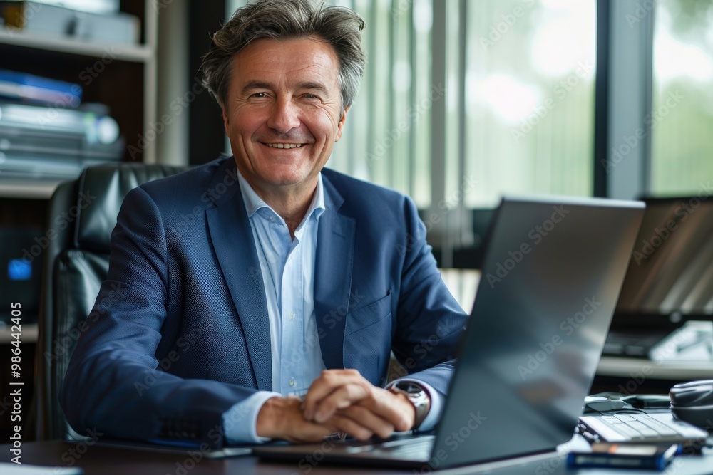 A man in a suit is sitting at a desk with a laptop in front of him, generative ai A man in a suit is sitting at a desk with a laptop in front of him, generative ai