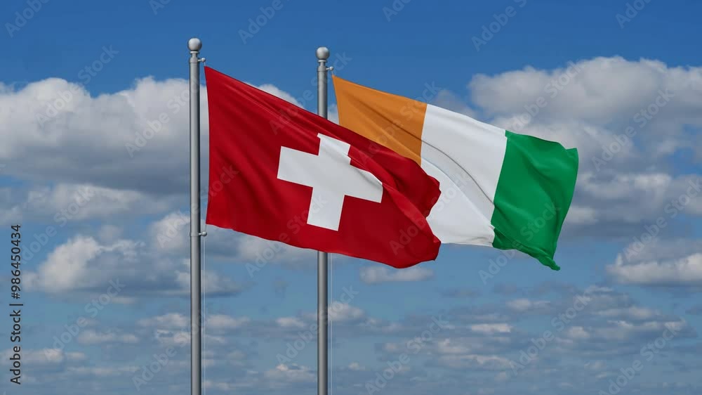 Ivory Coast or Cote d'Ivoire and Switzerland flags flying together, video concept of the relationship, two country cooperation concept Ivory Coast or Cote d'Ivoire and Switzerland flags flying together, video concept of the relationship, two country cooperation concept