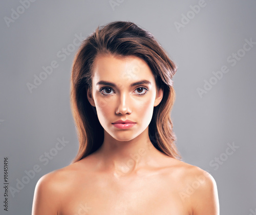 Beauty, hairstyle and shine with portrait of woman in studio for glow, volume and treatment. Scalp health, makeup and growth with person on gray background for haircare cosmetics, salon and keratin