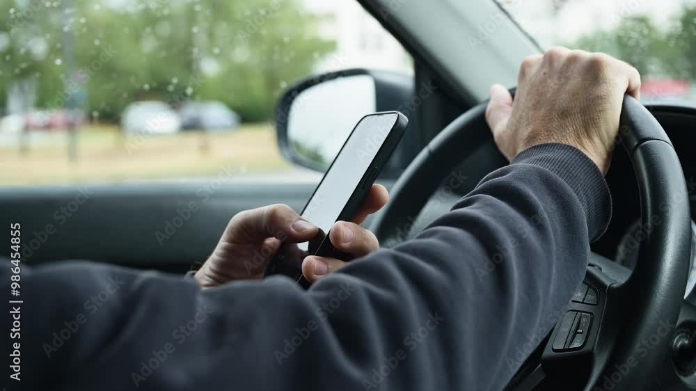 Male driver is driving car and texting on mobile phone, 4k slow motion