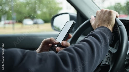 Male driver is driving car and texting on mobile phone, 4k slow motion