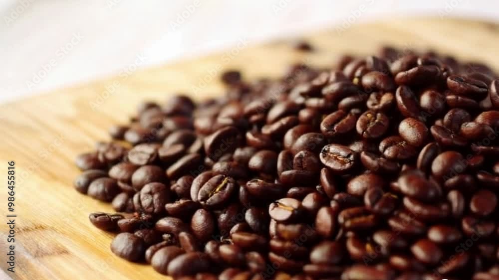 Whole coffee beans are sprinkled on a cutting board