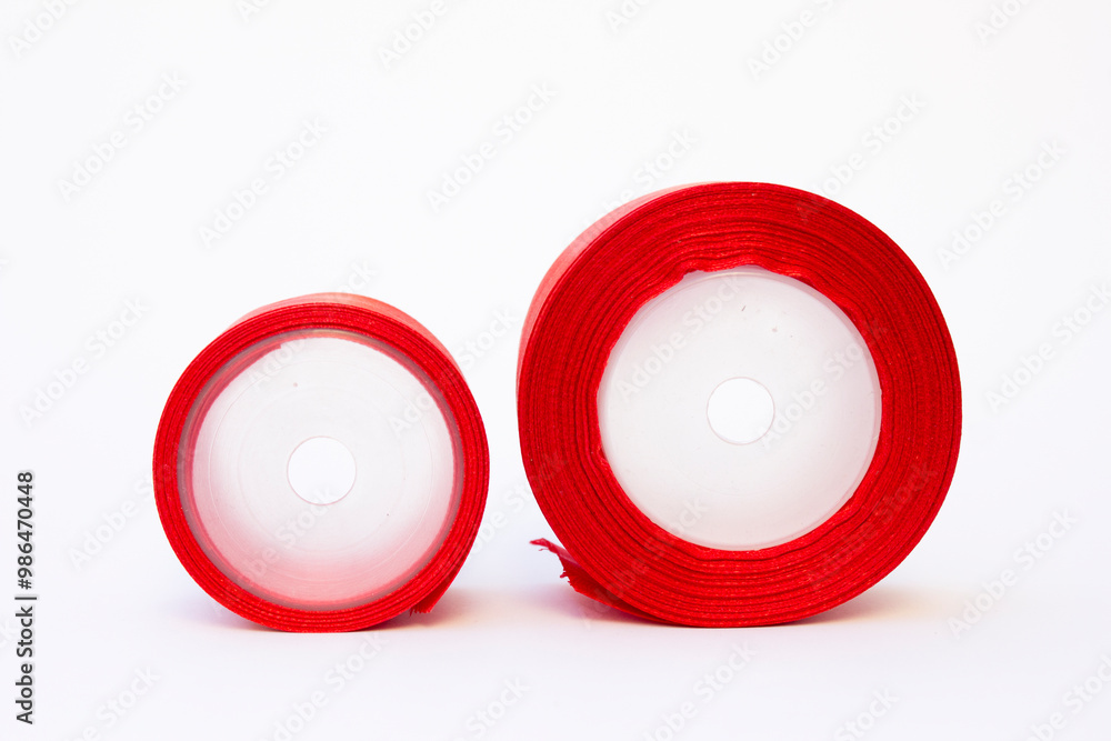 Two rolls of red-colored ribbon cloth. This ribbon can be used to make various decorations or to make clothes or ribbons. Two rolls of red-colored ribbon cloth. This ribbon can be used to make various decorations or to make clothes or ribbons.