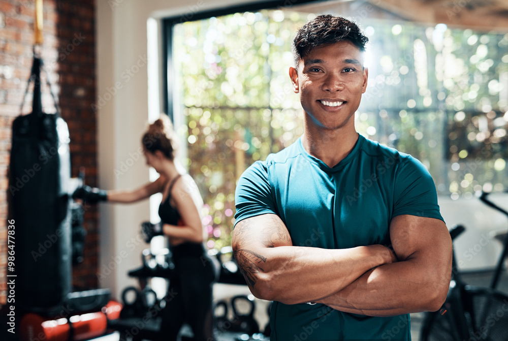 Man, portrait and smile in gym, personal trainer and practice with instructor, energy or boxing. Health club, sports and endurance of boxer, people and arms crossed for workout or exercise in morning Man, portrait and smile in gym, personal trainer and practice with instructor, energy or boxing. Health club, sports and endurance of boxer, people and arms crossed for workout or exercise in morning