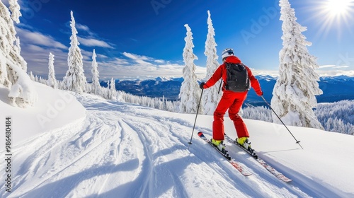 A skier in a red outfit glides down a snow-covered slope, flanked by frosted trees, enjoying a clear sky and bright sunlight during a winter adventure in the mountains photo