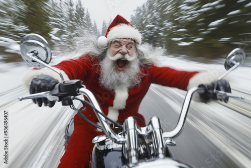 Cheerful Santa Claus is racing on a bike along a snowy highway. He is hurrying to the children for the holiday.