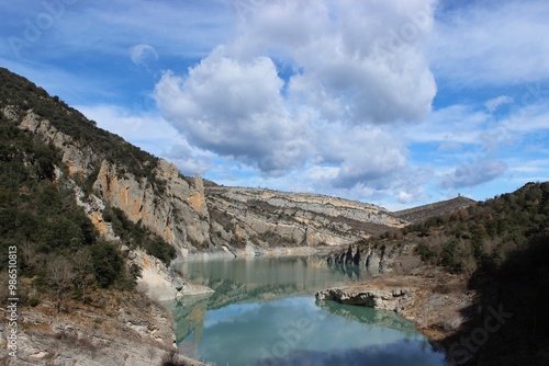 lake between mountains with clouds in the sky