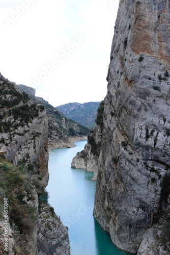 lake runs between two mountains on a cloudy day