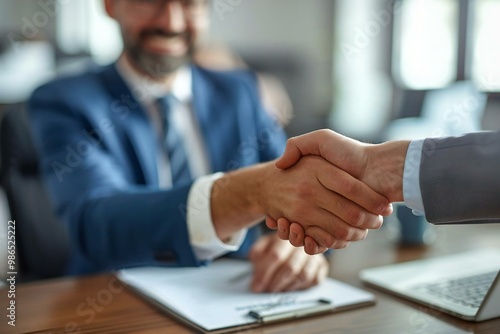 Businessman and Female Applicant Shake Hands in Elevated View at Workplace