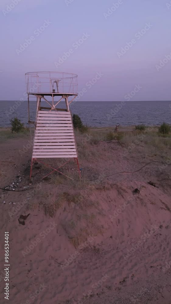 white wooden lighthouse by the sea at red pink romantic sunset drone shot white wooden lighthouse by the sea at red pink romantic sunset drone shot