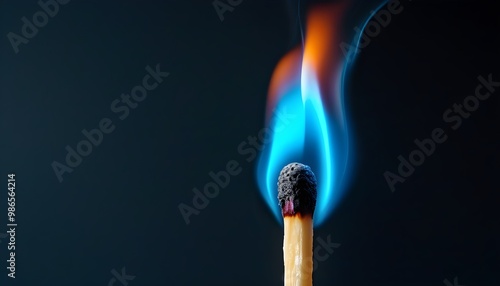 Fiery blue flame igniting a match against a deep dark backdrop