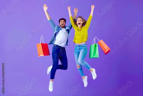 Full body side view young couple two friends family man woman wear casual clothes together hold shopping package bags jump high isolated on plain purple background. Black Friday sale buy day concept