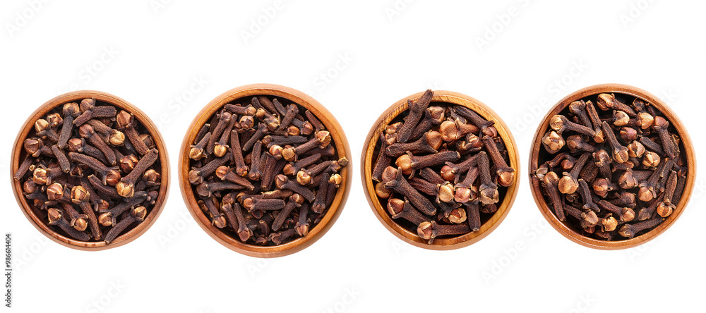 An overhead perspective of a wooden bowl filled with dried cloves, emphasizing their unique shape and color An overhead perspective of a wooden bowl filled with dried cloves, emphasizing their unique shape and color
