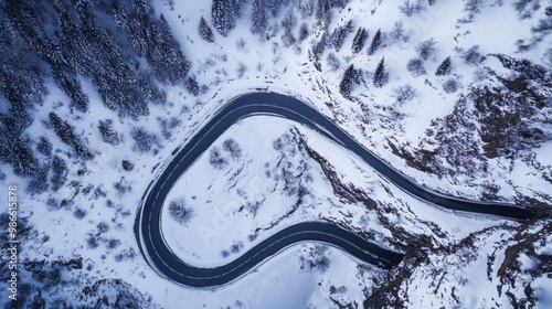 Aerial View of a Winding Road in a Snowy Mountain Landscape