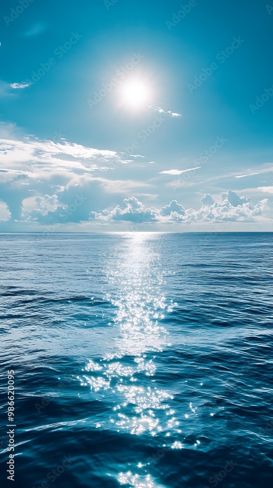 Fototapeta premium Tranquil Blue Ocean with Sun Glimmering on Water Surface