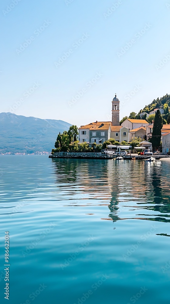 Naklejka premium Tranquil coastal village with church steeple and turquoise water