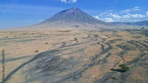 Aerial view highlights a desert landscape with a Ol Doinyo Lengai volcano