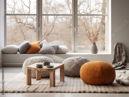 Modern interior design of scandinavian living room with chunky knit textured pouffs in autumn and neutral colors photo