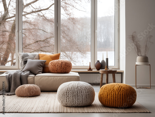 Modern interior design of scandinavian living room with chunky knit textured pouffs in autumn and neutral colors photo