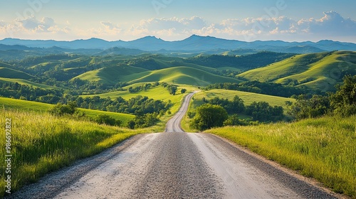 Winding Road Through Rolling Green Hills and Mountains