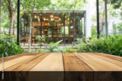 Empty wooden table top with blurred bokeh background of green garden and modern coffee shop interior, high definition wide-angle shot, boho aesthetic for product display.