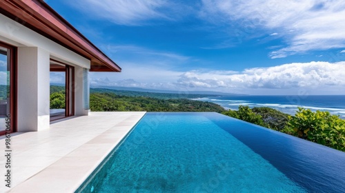 A luxury infinity pool with panoramic ocean views, offering a tranquil retreat in a tropical setting, under a bright blue sky..