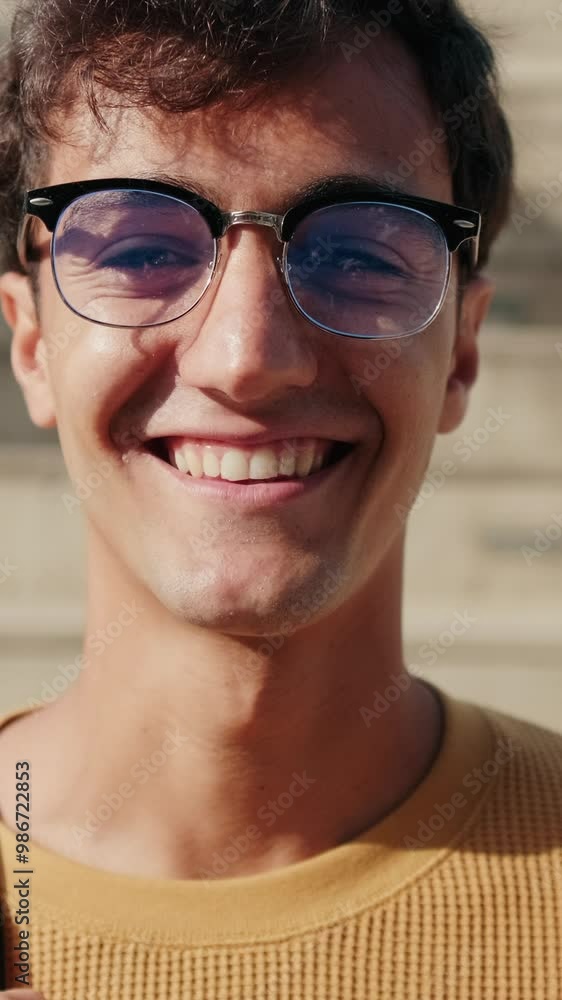 Portrait of cheerful European boy with glasses, male student with his friends in the background Portrait of cheerful European boy with glasses, male student with his friends in the background