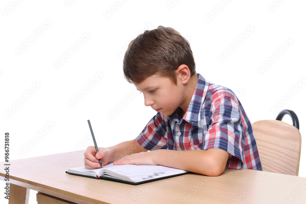 Boy with incorrect posture and notebook at wooden desk on white background Boy with incorrect posture and notebook at wooden desk on white background