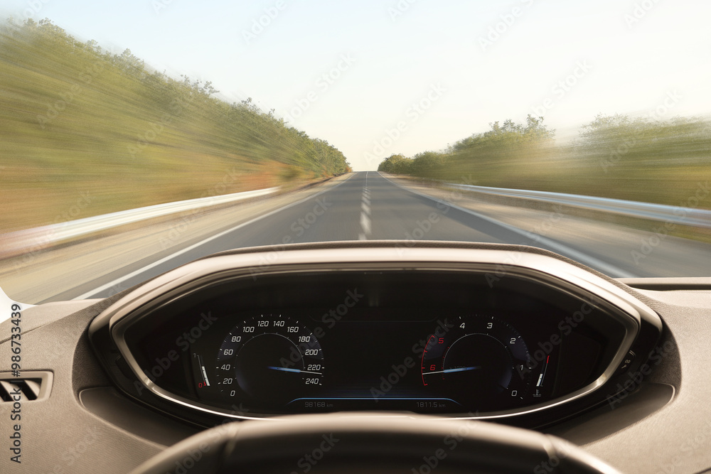 Car driving on empty road at high speed, view from driver's seat. Motion blur effect Car driving on empty road at high speed, view from driver's seat. Motion blur effect