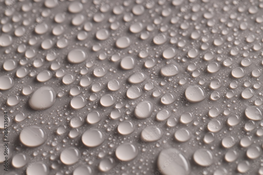 Water drops on gray background, closeup view Water drops on gray background, closeup view