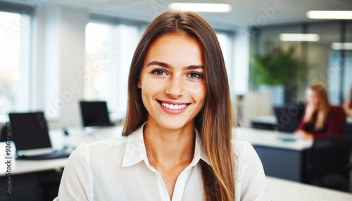 a beautiful young woman with blonde hair, a company employee, smiles at the camera while in the office Free Download a beautiful young woman with blonde hair, a company employee, smiles at the camera while in the office - GFXLoad