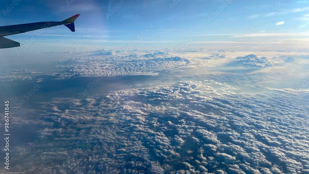 A stunning view of the clouds from an airplane window, showcasing the beauty of aerial perspective. A stunning view of the clouds from an airplane window, showcasing the beauty of aerial perspective.