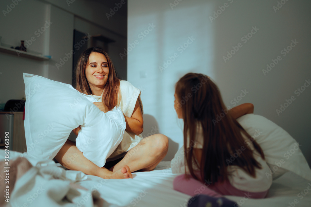 Happy Mother and Daughter Starting a Pillow fight at Home. Cheerful family having fun in the m morning full of energy
Happy Mother and Daughter Starting a Pillow fight at Home. Cheerful family having fun in the m morning full of energy