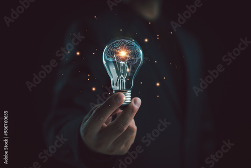 Businessman holding light bulb with brain inside, Idea, imagination, Creative, inspiration, Science innovation with network connection, Solution analysis and development, Innovative technology.