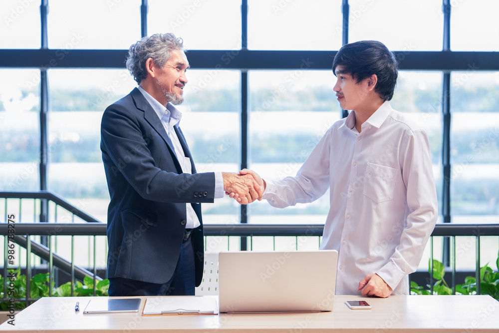professor doing handshake after giving advice university student,young asian man standing and conversation with advisor teacher professor doing handshake after giving advice university student,young asian man standing and conversation with advisor teacher