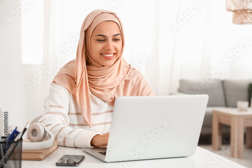 Young Muslim woman working ...