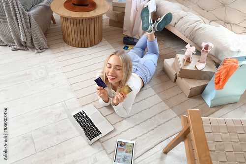 Young woman with laptop, ta...