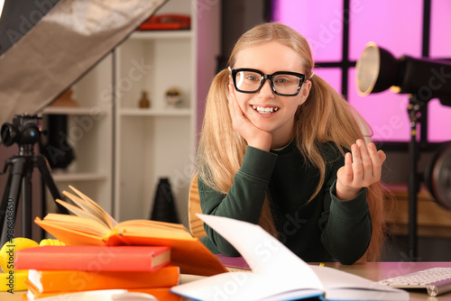 Teenage blogger studying an...