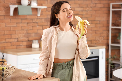 Young woman eating banana i...