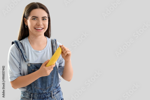Young woman peeling banana ...