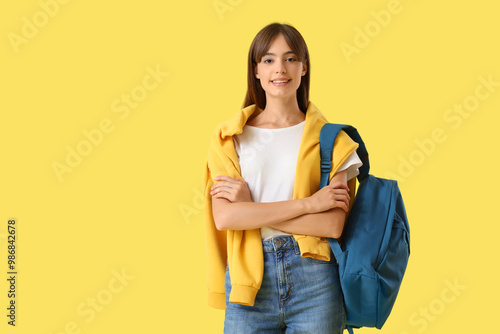 Happy female student with b...