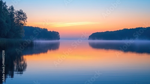 Outdoor photography at dawn, capturing the soft glow of the sunrise over a peaceful lake