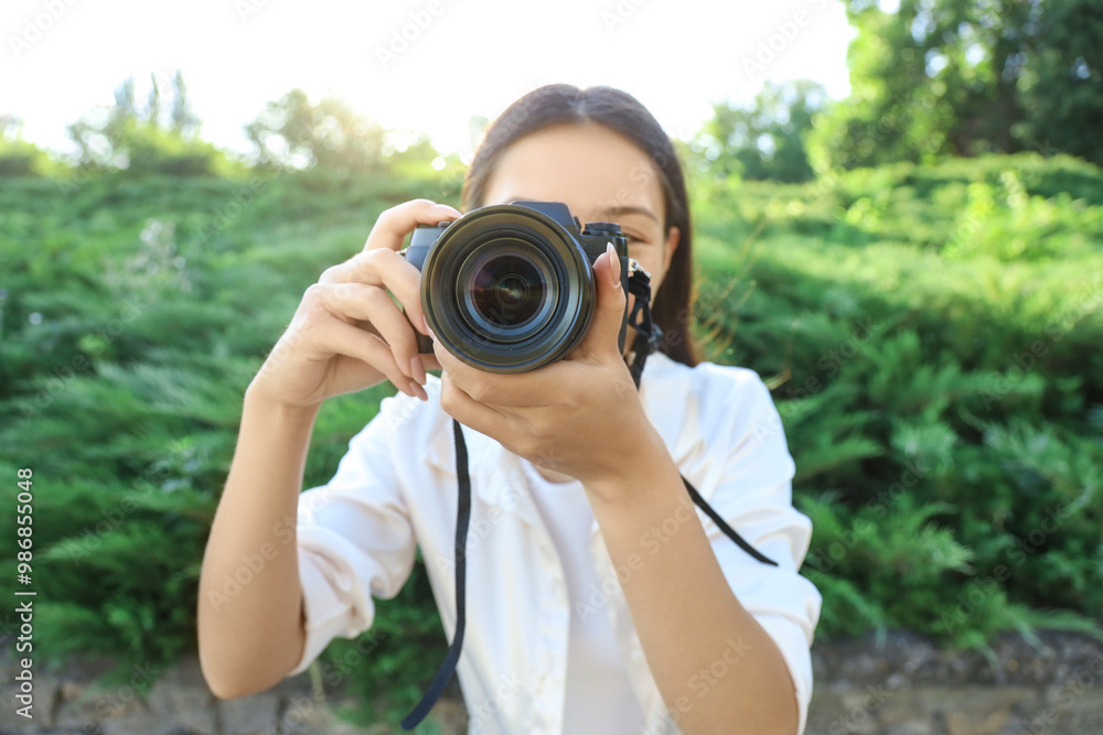 Female photographer with camera in park, closeup Female photographer with camera in park, closeup